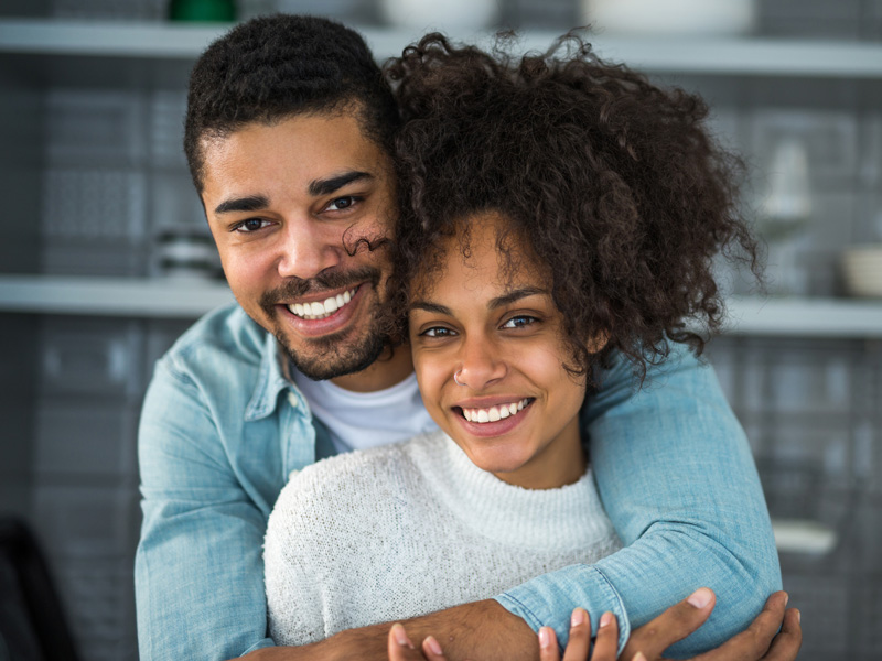 couple smiling and hugging