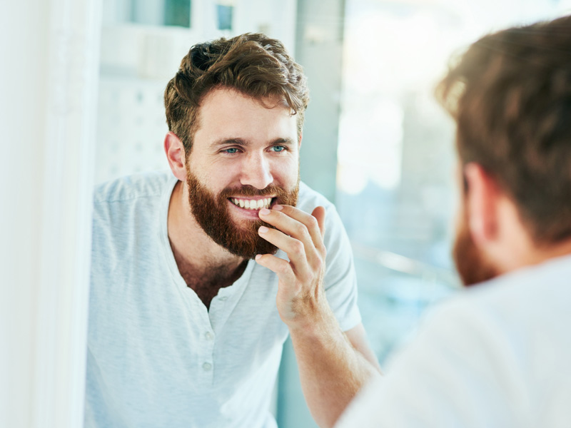 man smiling in mirror