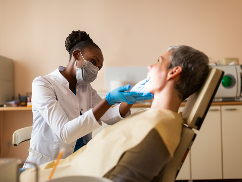 dentist looking at patients mouth