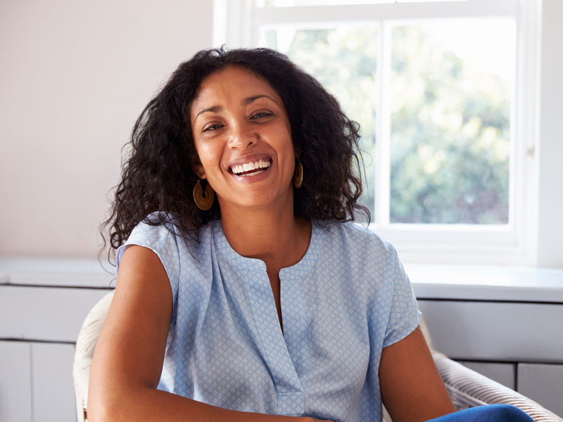 lady smiling sitting in a chair